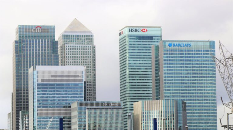 A split image showing a traditional bank building on one side and a modern smartphone with digital banking UI on the other, symbolizing legacy banks losing share to digital challengers.