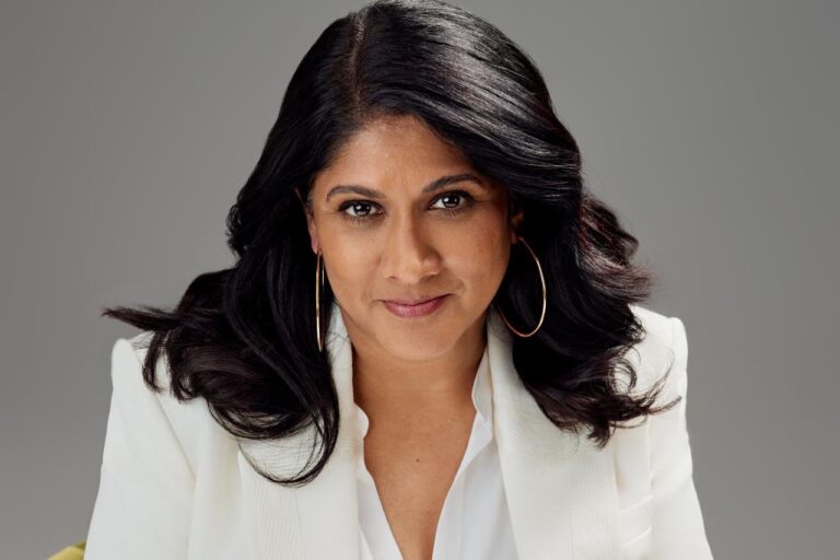 Priya Nair, dressed in professional business attire, delivering remarks at a conference, signifying her ascent as the first female CEO of Hindustan Unilever